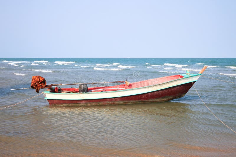 Wooden fishing boat on the beach stock image Wooden fishing boat on the beach stock image