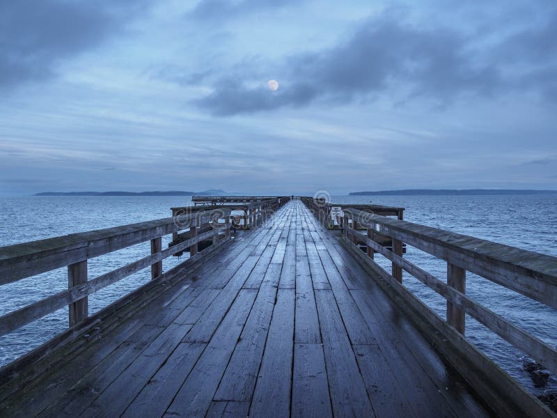 Wooden Fishing Pier Extending from Shore into the Ocean Stock Photo ...