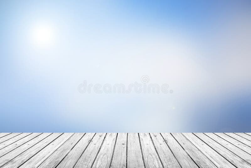 Wooden floor with blue sky blurred background