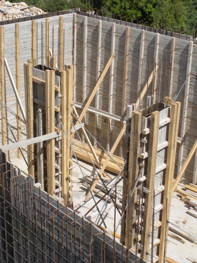 Wooden Forms Encase Reinforced Concrete Columns at a Construction Site