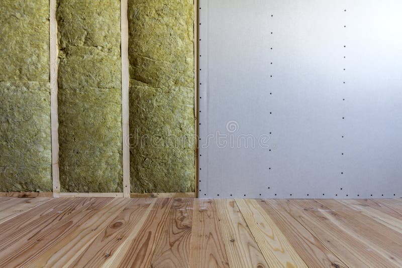 Wooden frame for future walls with drywall plates insulated with rock wool and fiberglass insulation staff for cold barrier. Comfortable warm home, economy, construction and renovation concept.