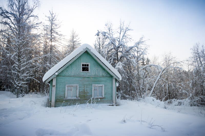 Wooden house in snow-covered Russian wood