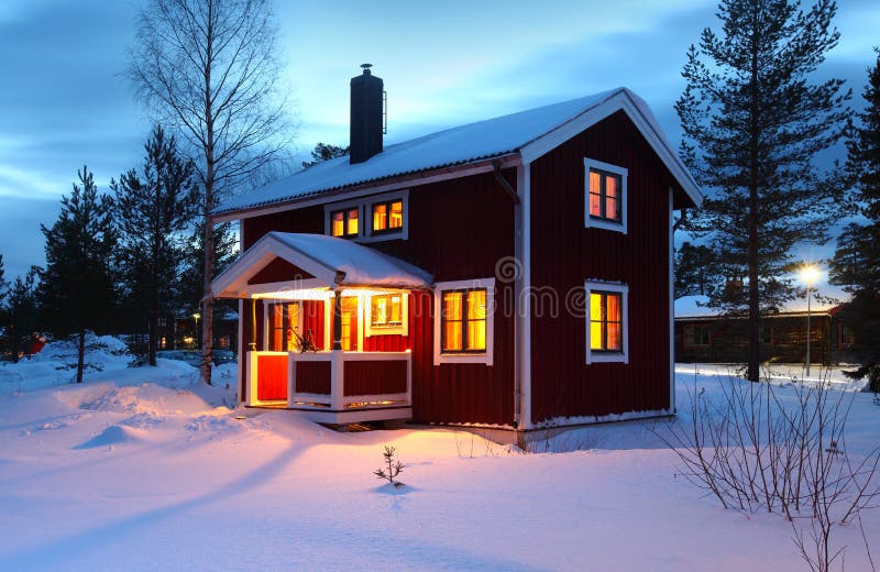 Wooden house in Sweden during winter by night