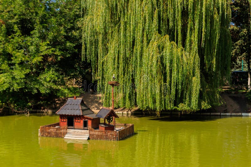 Wooden house for water birds and turtles on lake in city park royalty free stock photos