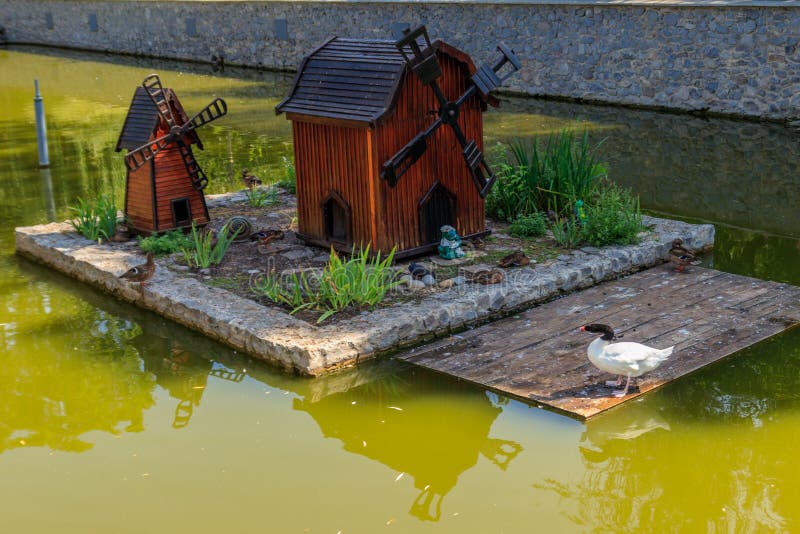 Wooden house for water birds and turtles on lake in city park stock photos
