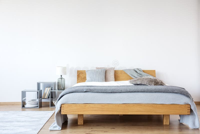 Wooden king-size bed in bedroom