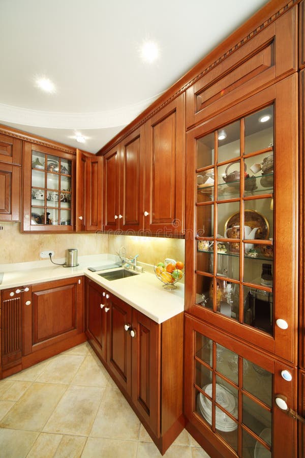 Simple Wooden Kitchen Cupboards, Countertops, Refrigerator Stock Photo