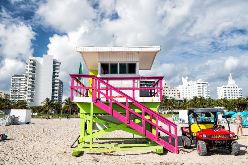 Wooden lifeguard tower and jeep car on sandy beach