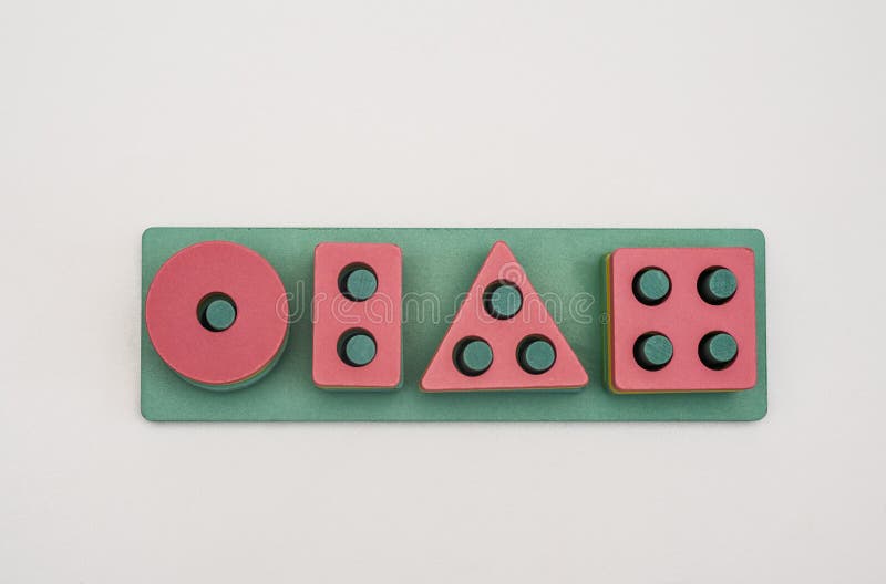 Wooden logic game of shapes with holes - circle, square, triangle, rectangle. Montessori child development. A wooden logic game made of shapes with holes. child development. on a white background