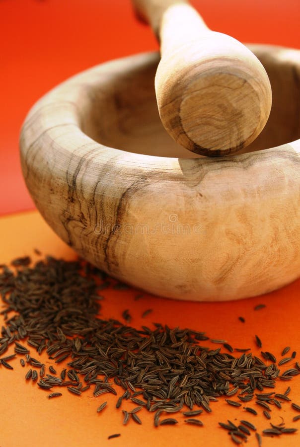 Wooden mortar and cumin