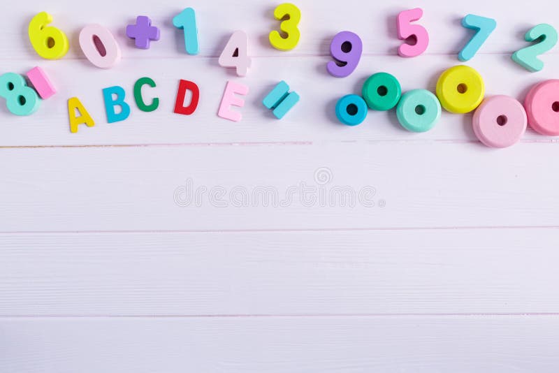 Wooden Numbers, Blocks, Pastel Color on Pink Background. Natural No