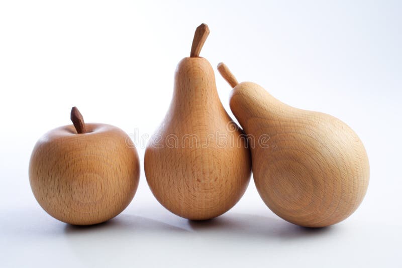 Wooden pears with an apple