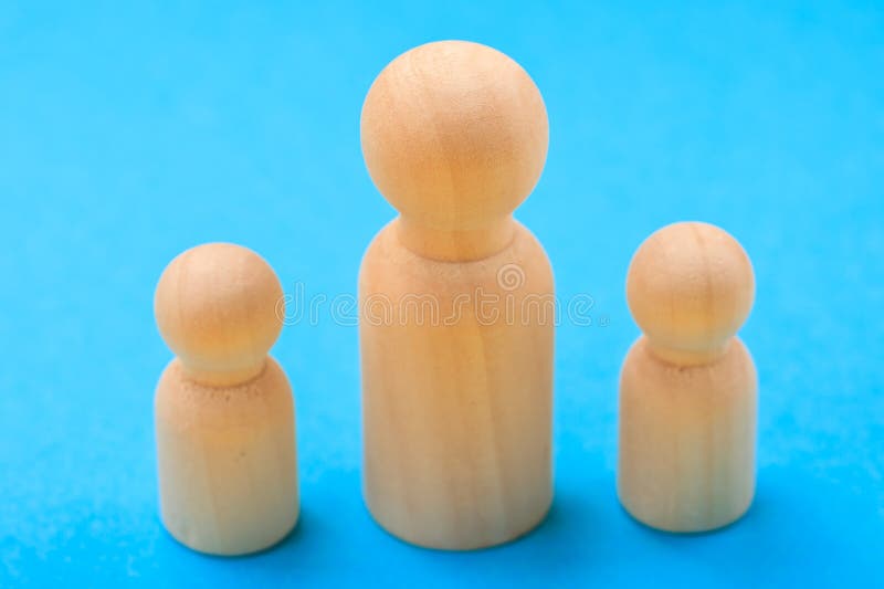 Wooden peg dolls family on blue background royalty free stock image