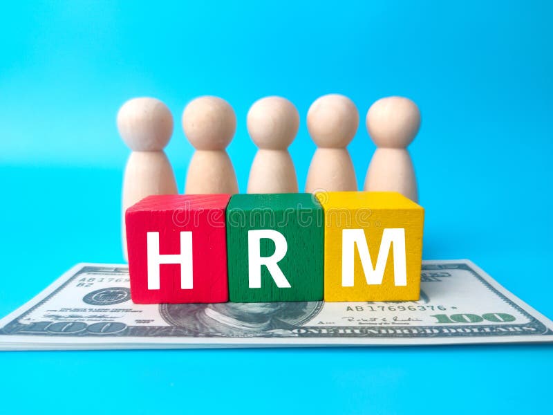 Wooden people figures,colored block and banknotes with text HRM stock images