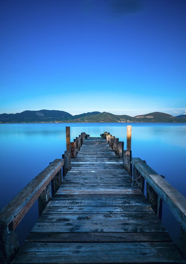 Wooden Pier or Jetty on a Blue Lake Sunset and Sky Reflection on Stock ...