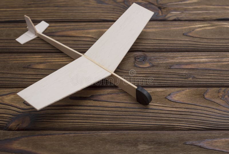 Wooden plane made a child on the background of wood. The old toy. stock photography Wooden plane made a child on the background of wood. The old toy. stock photography