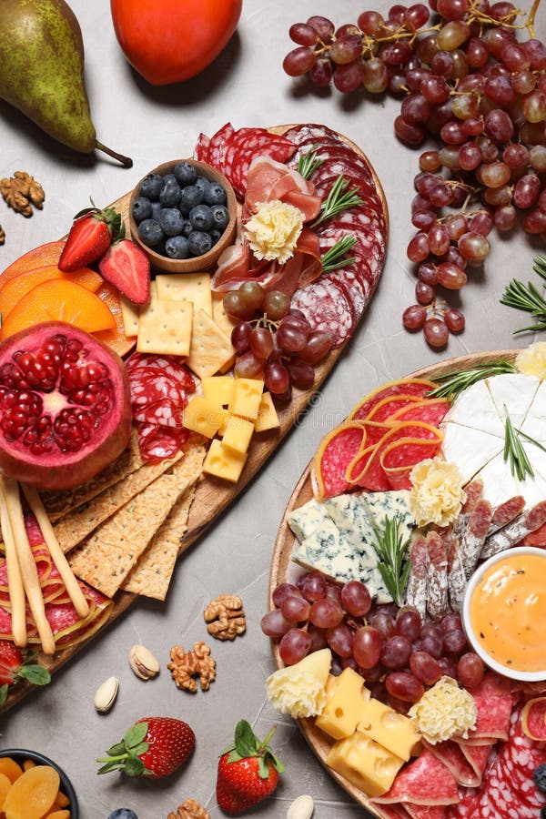 Wooden Plates with Different Delicious Snacks on Grey Table, Flat Lay