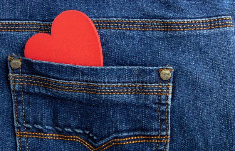 Wooden red heart in jeans pocket isolated on background.valentines day concept