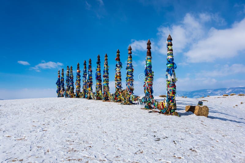 Wooden ritual pillars with colorful ribbons on cape Burkhan