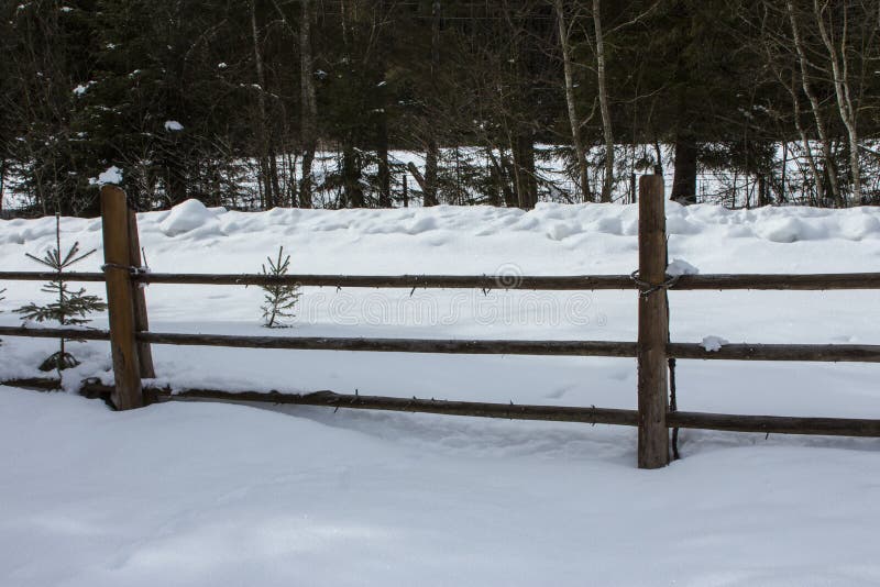 Wooden rural fence near a snowy mountain road stock images Wooden rural fence near a snowy mountain road stock images