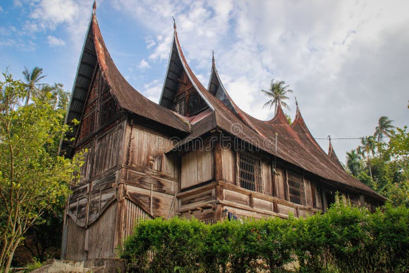 Wooden rural house with an unusual roof in the village of the Minangkabau people on the island of Sumatra royalty free stock photos Wooden rural house with an unusual roof in the village of the Minangkabau people on the island of Sumatra royalty free stock photos