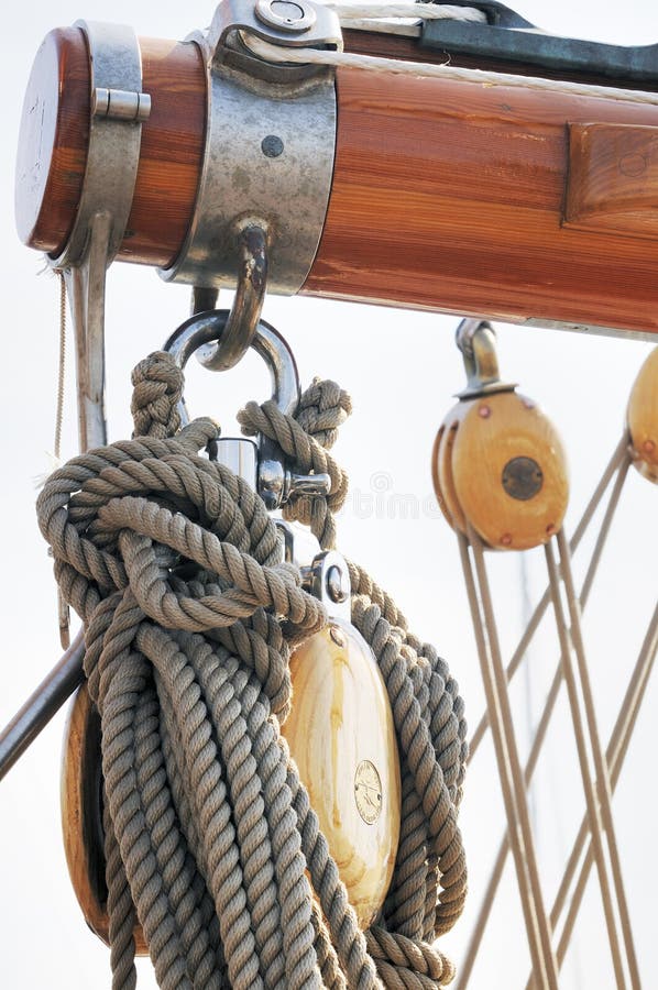 Wooden boom with blocks and ropes on a sailboat. Wooden boom with blocks and ropes on a sailboat