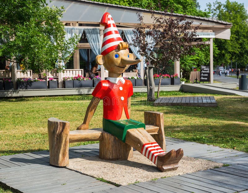 Wooden sculpture of Buratino (Russian Pinocchio) in the park. MOSCOW, RUSSIA - June 19, 2018: Wooden sculpture of Buratino (Russian Pinocchio)in the park royalty free stock photography Wooden sculpture of Buratino (Russian Pinocchio) in the park. MOSCOW, RUSSIA - June 19, 2018: Wooden sculpture of Buratino (Russian Pinocchio)in the park royalty free stock photography