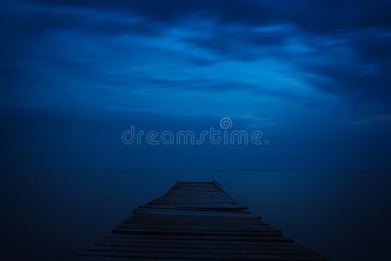 Wooden sea pier night. Dark sky with clouds royalty free stock photography Wooden sea pier night. Dark sky with clouds royalty free stock photography