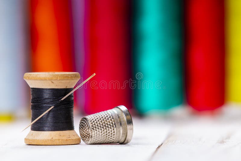 Wooden Sewing Spool with Black Thread and Metal Thimble Stock Image