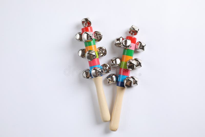 Wooden shakers with bells on white background, top view. Montessori musical toy