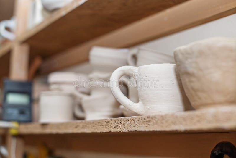 Wooden Shelving in Pottery Which Has Pottery Standing on