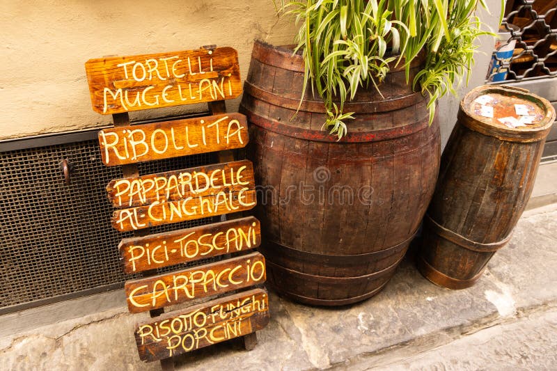 Wooden Sign with a Typical Tuscan Menu in a Street of Touristic City of Wooden Sign with a Typical Tuscan Menu in a Street of Touristic City of