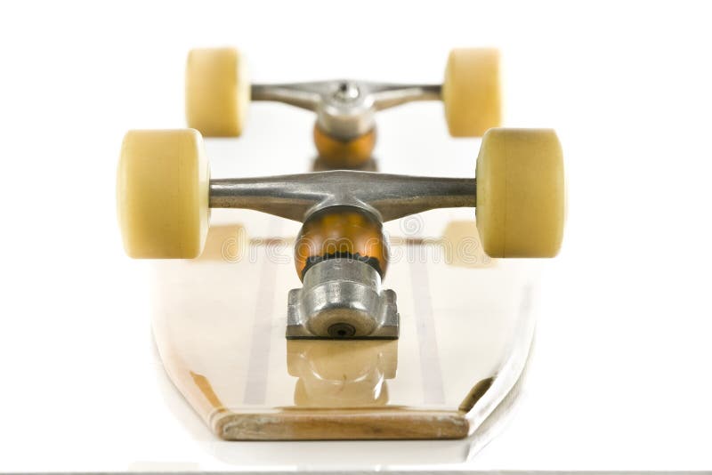 Wooden skate board on it's back on a white background. Wooden skate board on it's back on a white background