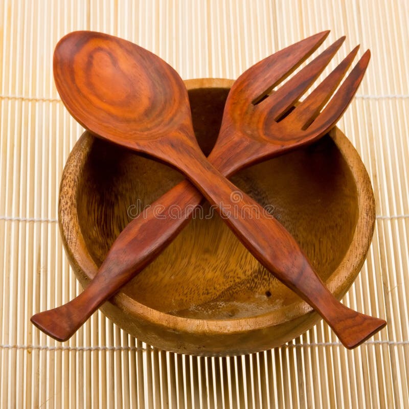 Wooden spoon, fork and basi on bamboo