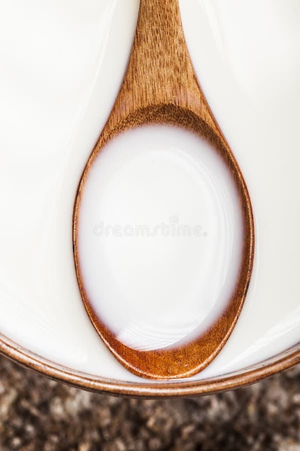 Wooden spoon with milk