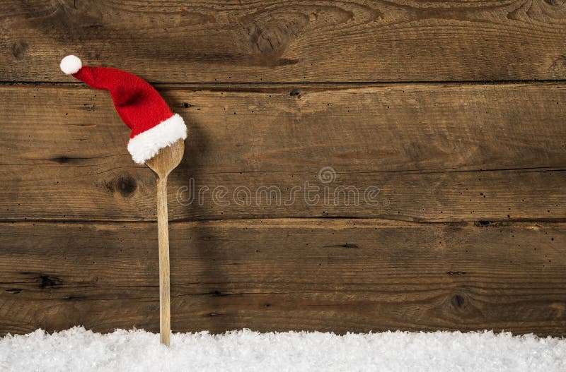 Wooden spoon with red santa hat: rustic christmas background. Vintage rustic recipe book background stock images, royalty-free photos and pictures