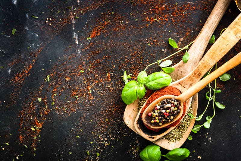 Wooden spoons with spices and herbs