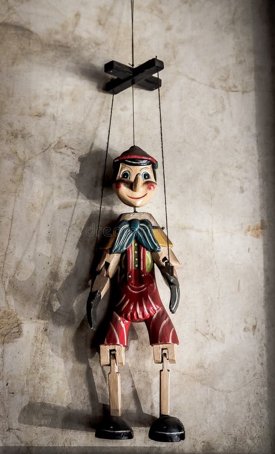 Selective Focus Abstract image of a Wooden String Puppet Boy hanging on a wall. Little marionette stock images, royalty-free photos and pictures