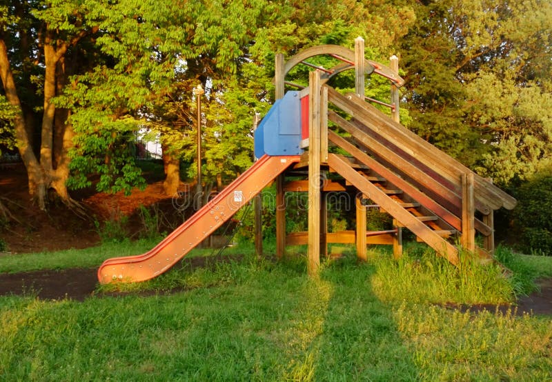 Wooden Slide For Children In Winter, Children With Sledges And Tubing