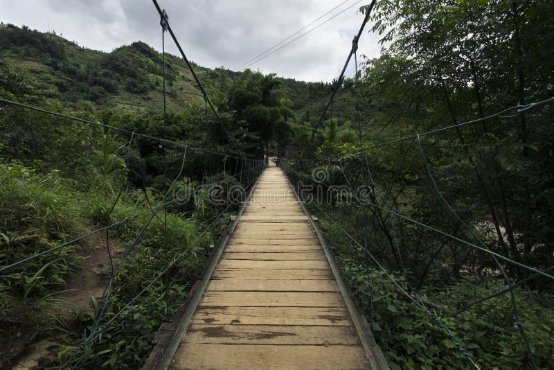 Wooden suspension bridge in the forest of Sapa, Lao Cai, Vietnam royalty free stock image Wooden suspension bridge in the forest of Sapa, Lao Cai, Vietnam royalty free stock image