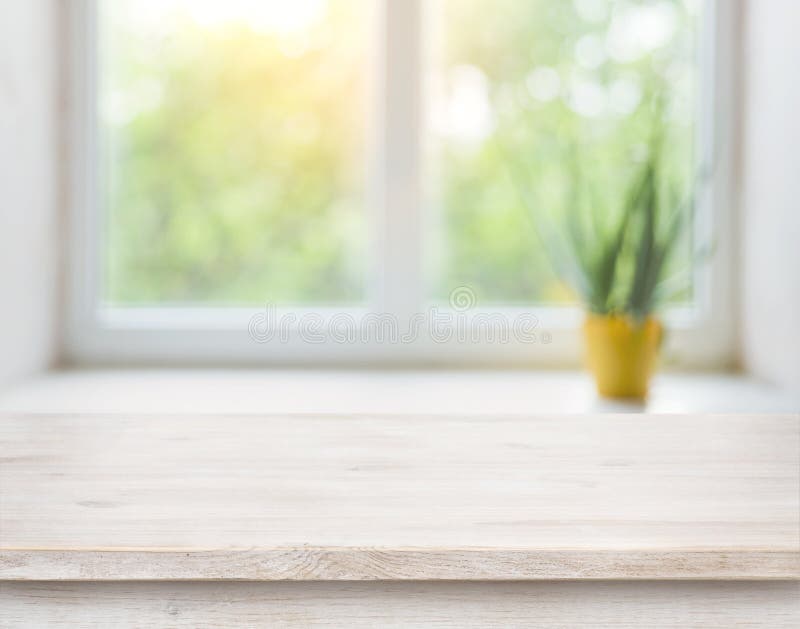 wooden table on blurred autumn window with plant pot