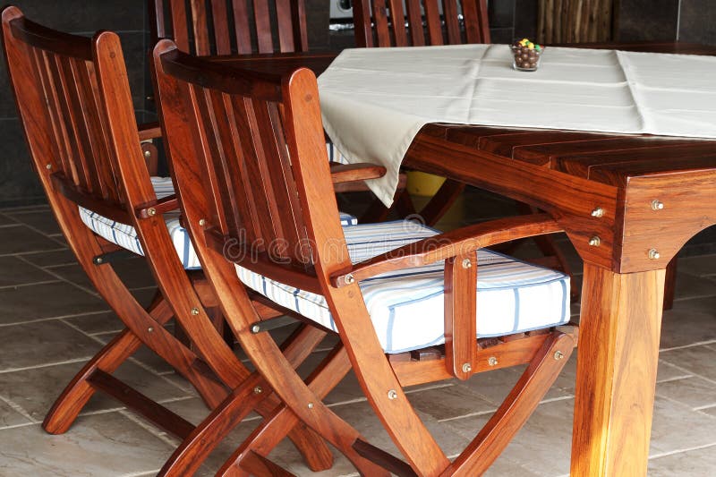 Wooden table and chairs stock image. Image of orange, pillow - 5159573