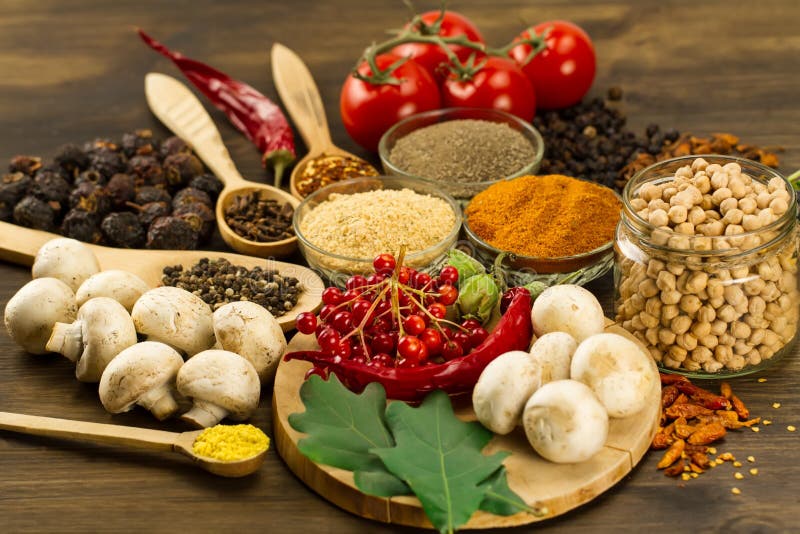 Wooden table with colorful spices, herbs and vegetables. stock photo Wooden table with colorful spices, herbs and vegetables. stock photo