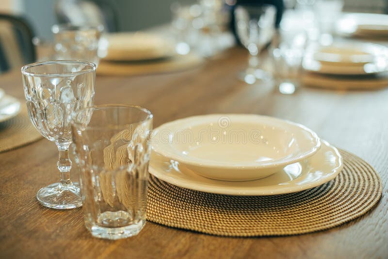 Wooden Table with Empty Plates and Glasses. Dinner Table Setting Stock