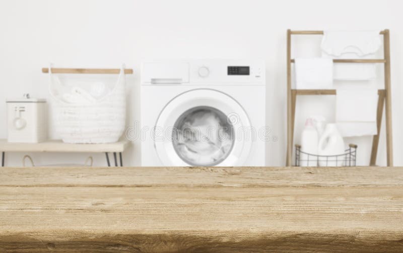 Wooden Table in Front of Washing Machine Loaded with Laundry Stock ...