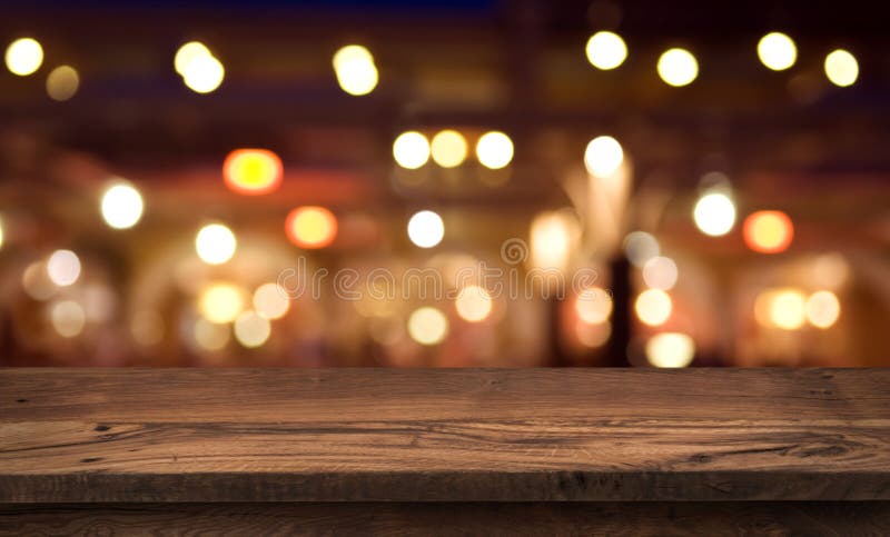 Wooden table for product display on abstract restaurant lights background