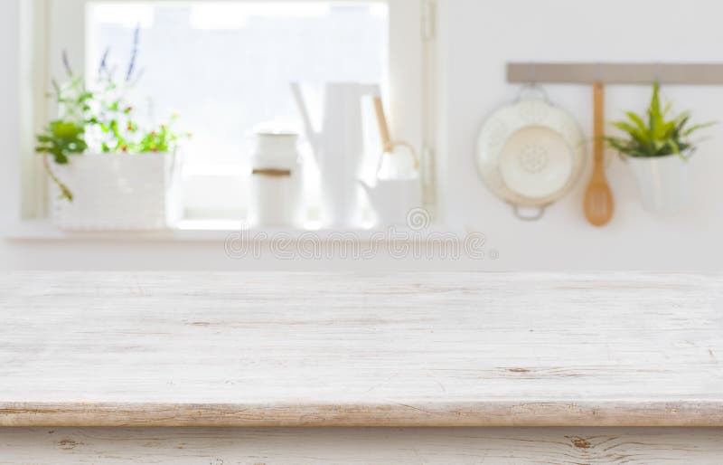 Wooden table top over blurred kitchen interior with copy space royalty free stock photography Wooden table top over blurred kitchen interior with copy space royalty free stock photography