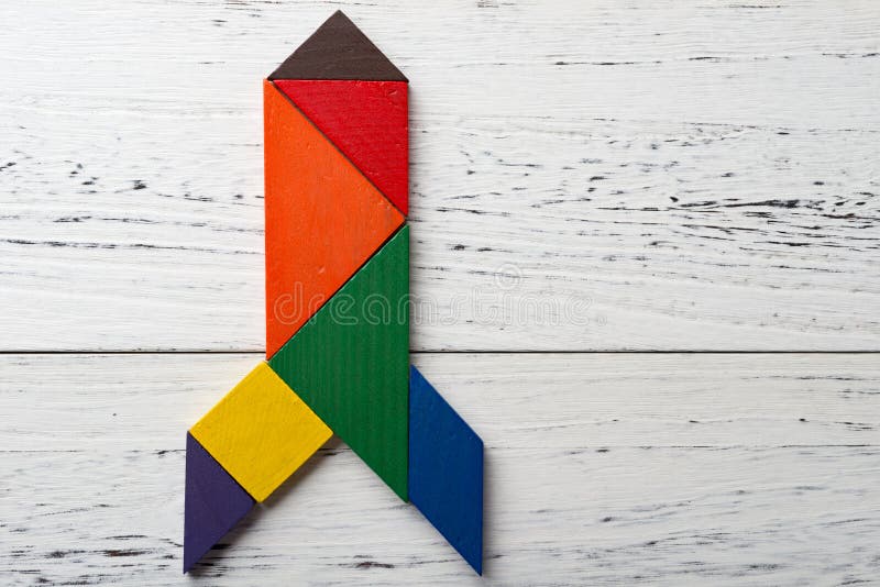 Wooden tangram in rocket shape stock photos