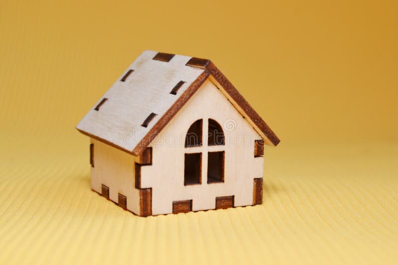Wooden Toy House Model on Yellow Background Side View Stock Image
