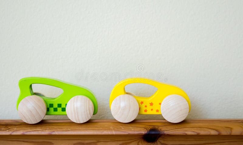 2 wooden toy race cars with copy space